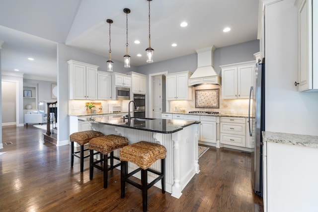 1825 Barnstaple Ln, Brentwood, TN 37027 - kitchen featuring appliances with stainless steel finishes, premium range hood, a sink, white cabinetry, and recessed lighting