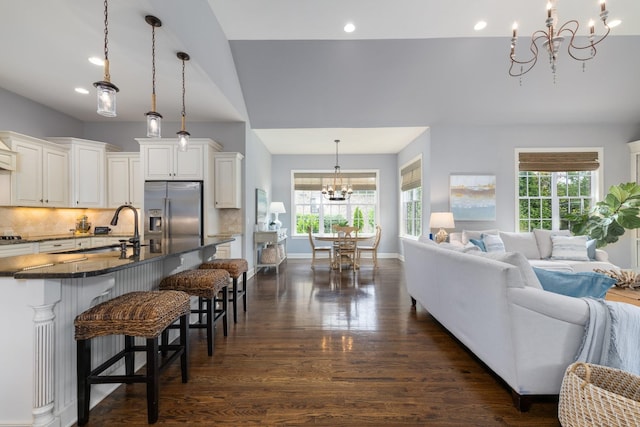 1825 Barnstaple Ln, Brentwood, TN 37027 - kitchen with stainless steel refrigerator with ice dispenser, a chandelier, open floor plan, dark countertops, and dark wood finished floors