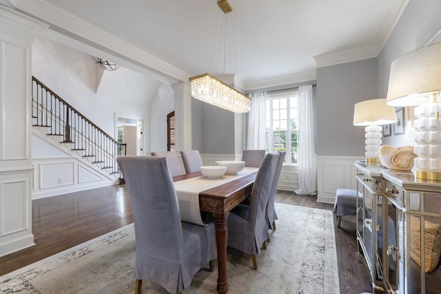 1825 Barnstaple Ln, Brentwood, TN 37027 - dining room with ornate columns, wood finished floors, a decorative wall, crown molding, and a wainscoted wall