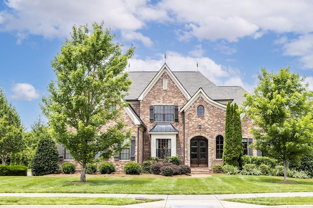 1825 Barnstaple Ln, Brentwood, TN 37027 - view of front facade with brick siding, a front lawn, a standing seam roof, and roof with shingles