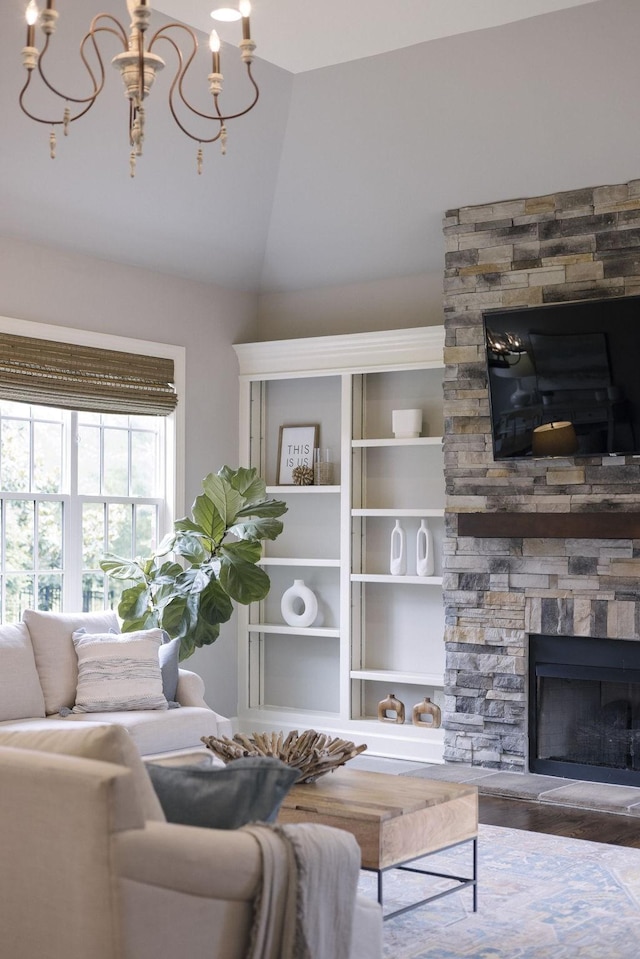 1825 Barnstaple Ln, Brentwood, TN 37027 - living room with a stone fireplace, wood finished floors, vaulted ceiling, and a chandelier