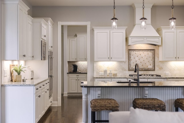 1825 Barnstaple Ln, Brentwood, TN 37027 - kitchen featuring white cabinets, decorative backsplash, dark wood-style floors, and decorative light fixtures