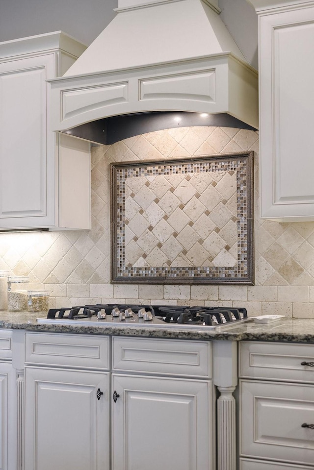 1825 Barnstaple Ln, Brentwood, TN 37027 - kitchen featuring decorative backsplash, custom range hood, white cabinets, stainless steel gas cooktop, and dark stone counters