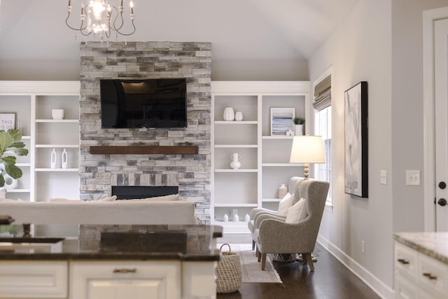 1825 Barnstaple Ln, Brentwood, TN 37027 - living area with a fireplace, baseboards, vaulted ceiling, a chandelier, and dark wood-style flooring
