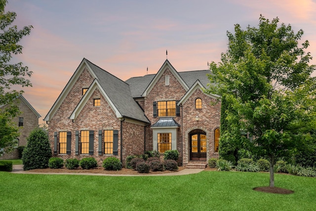 1825 Barnstaple Ln, Brentwood, TN 37027 - view of front of property with a lawn, brick siding, a standing seam roof, and a shingled roof