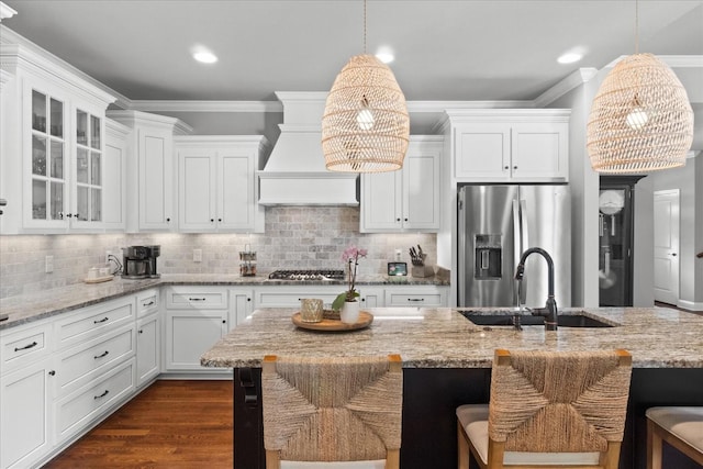 1076 Pretender Way, Columbia, TN 38401 - kitchen with stainless steel refrigerator with ice dispenser, a sink, white cabinetry, crown molding, and a kitchen bar