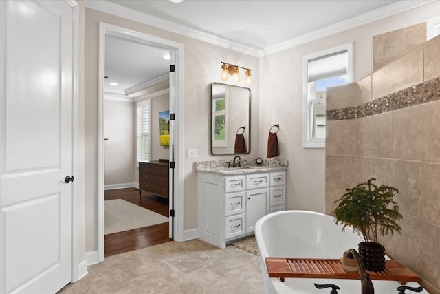 1076 Pretender Way, Columbia, TN 38401 - bathroom with ornamental molding, vanity, a freestanding tub, and baseboards
