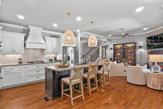 1076 Pretender Way, Columbia, TN 38401 - kitchen featuring appliances with stainless steel finishes, wall chimney range hood, a sink, open floor plan, and ceiling fan