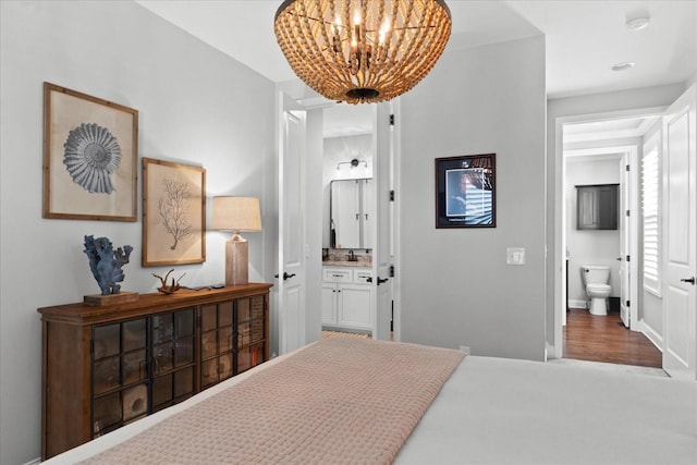 1076 Pretender Way, Columbia, TN 38401 - bedroom featuring ensuite bath, a chandelier, wood finished floors, and baseboards