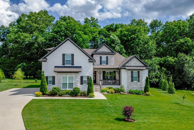 1076 Pretender Way, Columbia, TN 38401 - view of front of property with covered porch, a front lawn, stone siding, driveway, and brick siding