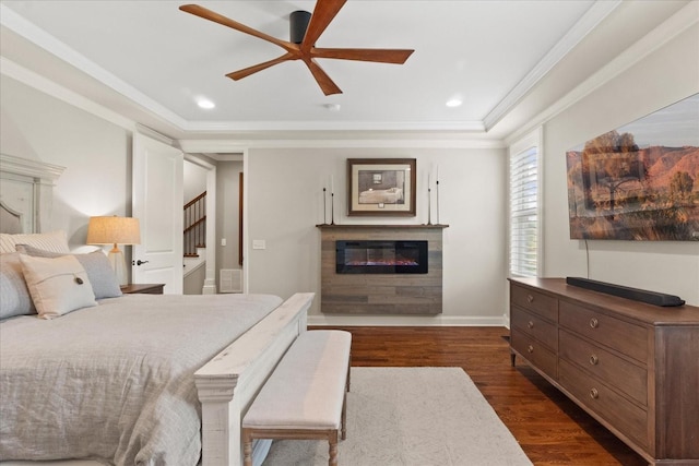 1076 Pretender Way, Columbia, TN 38401 - bedroom featuring a glass covered fireplace, dark wood-style floors, ornamental molding, recessed lighting, and baseboards