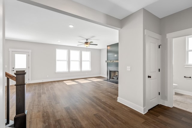 2655 Burton Dr, White House, TN 37188 - unfurnished living room featuring baseboards, dark wood-type flooring, a ceiling fan, a fireplace with flush hearth, and recessed lighting