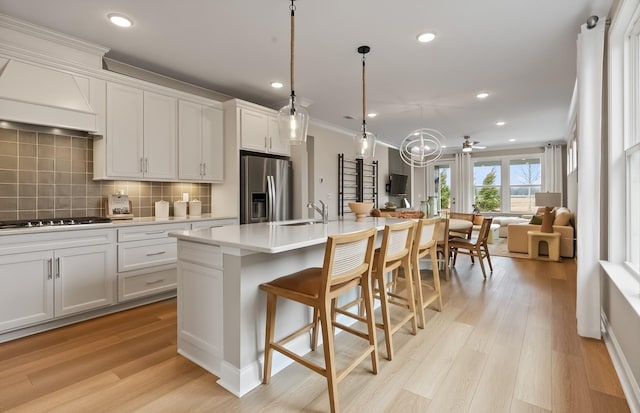 318 Sharp Way, Murfreesboro, TN 37128 - kitchen with stainless steel fridge with ice dispenser, open floor plan, black stovetop, a sink, and decorative backsplash