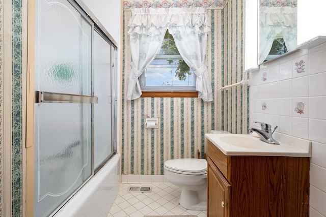 924 Shauna Dr, Nashville, TN 37214 - full bath featuring tile patterned floors, vanity, toilet, combined bath / shower with glass door, and wallpapered walls