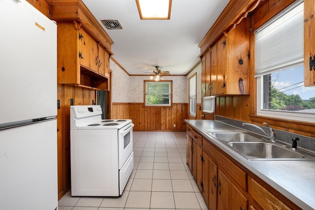 924 Shauna Dr, Nashville, TN 37214 - kitchen featuring white appliances, a sink, a wainscoted wall, wooden walls, and ceiling fan