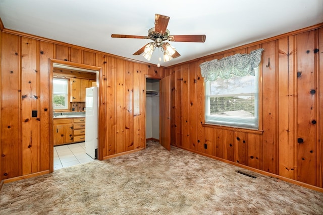 924 Shauna Dr, Nashville, TN 37214 - unfurnished bedroom with freestanding refrigerator, wooden walls, carpet, a closet, and ensuite bathroom