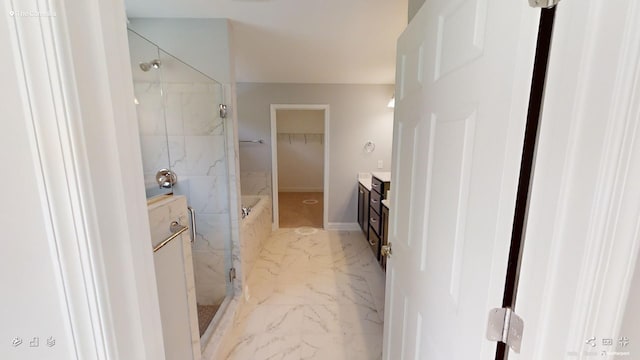 2408 Oakmont Ln, Mount Juliet, TN 37122 - bathroom featuring marble look tiles, vanity, a walk in shower, a walk in closet, and baseboards