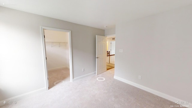 2408 Oakmont Ln, Mount Juliet, TN 37122 - unfurnished bedroom featuring a spacious closet, carpet floors, baseboards, and a closet