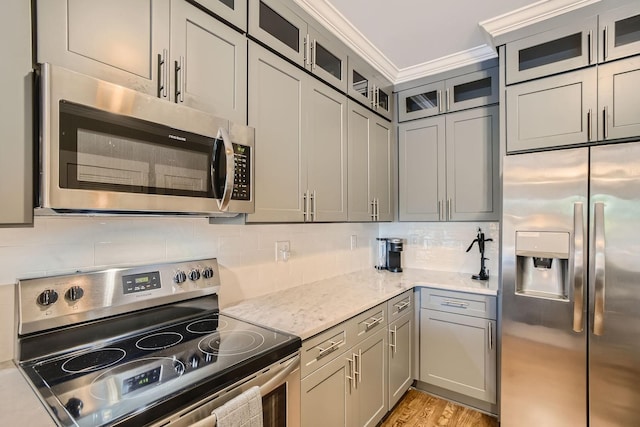 3303 Gallatin Pike Unit 202, Nashville, TN 37216 - kitchen with stainless steel appliances, light stone counters, tasteful backsplash, and gray cabinets