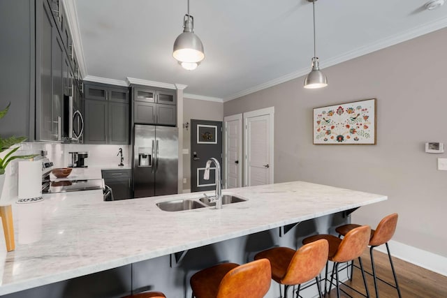 3303 Gallatin Pike Unit 202, Nashville, TN 37216 - kitchen with appliances with stainless steel finishes, a sink, a peninsula, ornamental molding, and dark wood-style floors
