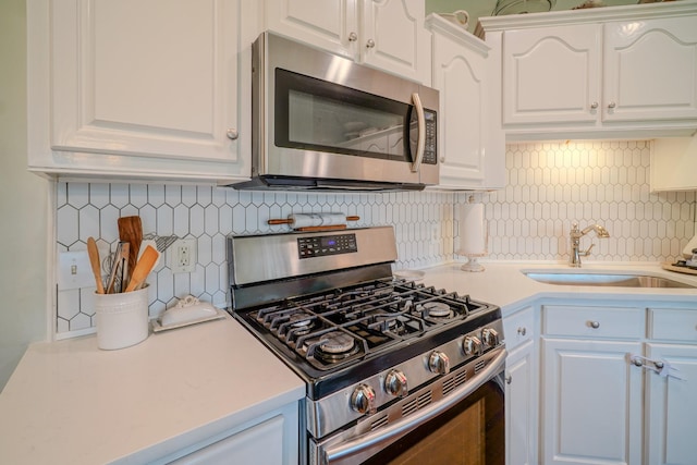 3302 Foxtrot Ct, Spring Hill, TN 37174 - kitchen with stainless steel appliances, a sink, tasteful backsplash, and white cabinetry