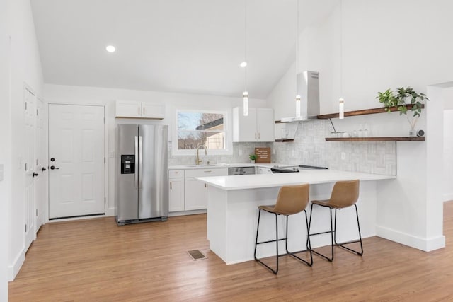 408 Adair Rd, Nashville, TN 37214 - kitchen with appliances with stainless steel finishes, island range hood, light countertops, tasteful backsplash, and vaulted ceiling
