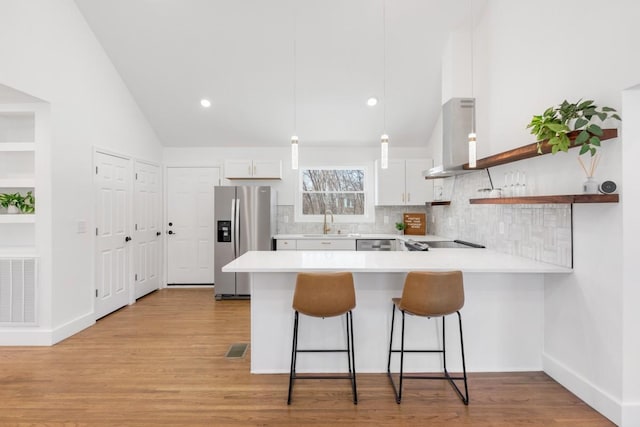 408 Adair Rd, Nashville, TN 37214 - kitchen with appliances with stainless steel finishes, ventilation hood, a peninsula, a sink, and light countertops