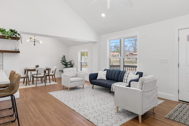 408 Adair Rd, Nashville, TN 37214 - living room with high vaulted ceiling, wood finished floors, ceiling fan, a chandelier, and baseboards