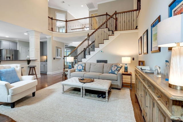 106 Ashton Park Blvd, Franklin, TN 37067 - living area with stairs, wood finished floors, ornamental molding, baseboards, and a high ceiling