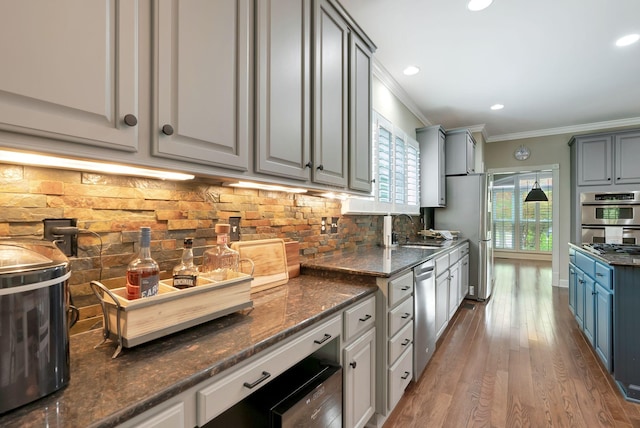 106 Ashton Park Blvd, Franklin, TN 37067 - kitchen with ornamental molding, a sink, appliances with stainless steel finishes, wood finished floors, and tasteful backsplash