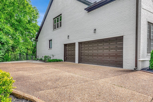 106 Ashton Park Blvd, Franklin, TN 37067 - view of side of home featuring brick siding, concrete driveway, and a garage