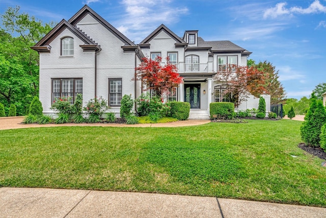 106 Ashton Park Blvd, Franklin, TN 37067 - view of front of house featuring a balcony, a front lawn, and brick siding