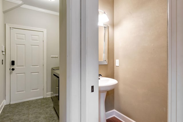 106 Ashton Park Blvd, Franklin, TN 37067 - bathroom with washer and dryer, crown molding, baseboards, a sink, and tile patterned floors