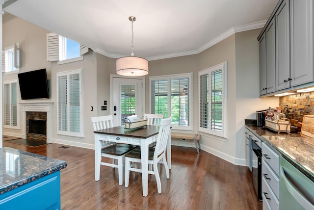 106 Ashton Park Blvd, Franklin, TN 37067 - dining room with dark wood-style floors, a stone fireplace, baseboards, and ornamental molding