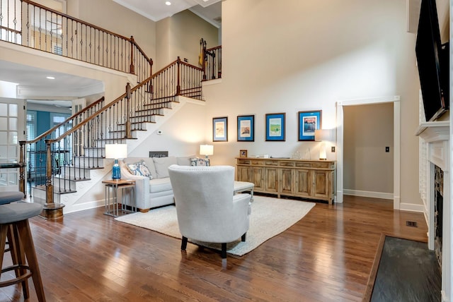 106 Ashton Park Blvd, Franklin, TN 37067 - living room featuring a towering ceiling, wood finished floors, ornamental molding, stairs, and baseboards
