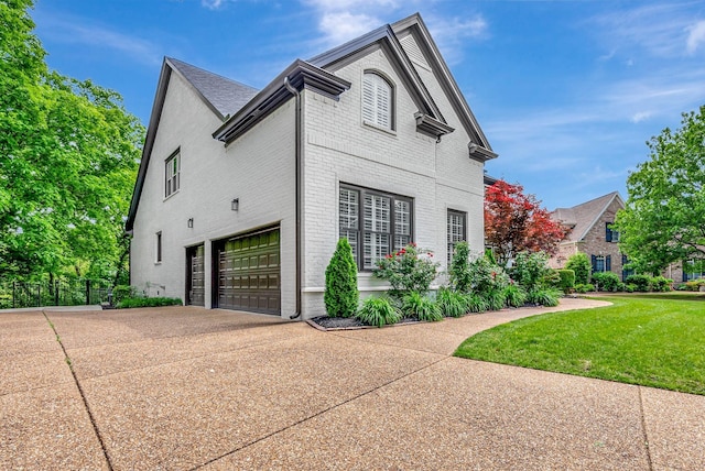 106 Ashton Park Blvd, Franklin, TN 37067 - view of property exterior featuring brick siding, a garage, and driveway