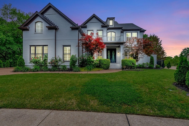 106 Ashton Park Blvd, Franklin, TN 37067 - french country style house with a balcony, a front lawn, brick siding, and french doors