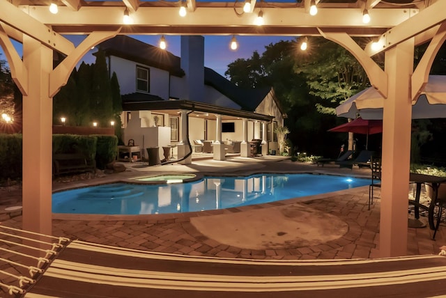 106 Ashton Park Blvd, Franklin, TN 37067 - pool at night with a patio area and a pool with connected hot tub