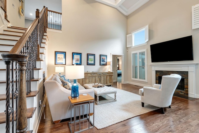106 Ashton Park Blvd, Franklin, TN 37067 - living area featuring a high ceiling, a fireplace, stairs, wood finished floors, and baseboards