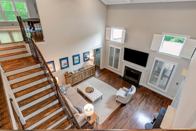 106 Ashton Park Blvd, Franklin, TN 37067 - living area featuring a high end fireplace, wood finished floors, a towering ceiling, stairway, and baseboards
