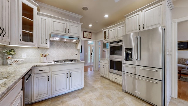 516 Letcher Ave, Lebanon, TN 37087 - kitchen with appliances with stainless steel finishes, under cabinet range hood, backsplash, recessed lighting, and ornamental molding