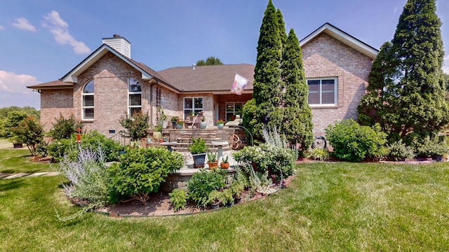 516 Letcher Ave, Lebanon, TN 37087 - back of property with brick siding, a lawn, and a chimney