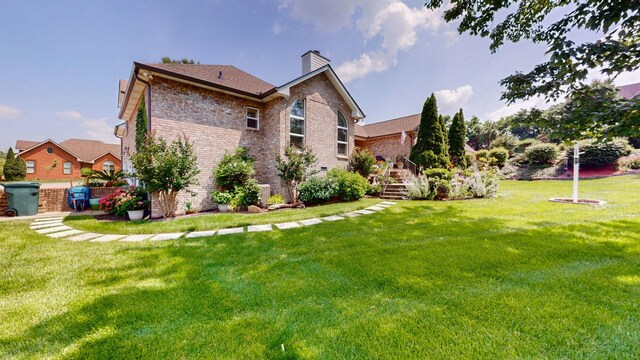 516 Letcher Ave, Lebanon, TN 37087 - rear view of house with a chimney, a yard, brick siding, and stairs