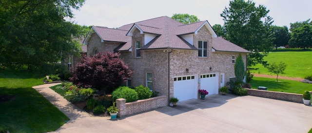 516 Letcher Ave, Lebanon, TN 37087 - view of property exterior featuring a lawn, a garage, driveway, brick siding, and roof with shingles