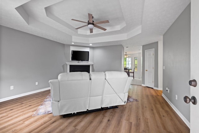 97 Whitefield Ln, Carthage, TN 37030 - living room with a ceiling fan, a tray ceiling, and baseboards