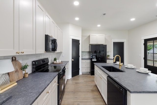 312 N Main St, Dickson, TN 37055 - kitchen with black appliances, a sink, dark countertops, recessed lighting, and decorative backsplash