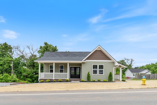 312 N Main St, Dickson, TN 37055 - view of front of home featuring french doors, covered porch, and a shingled roof