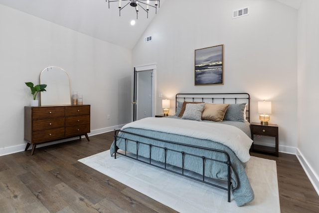 312 N Main St, Dickson, TN 37055 - bedroom with high vaulted ceiling, a chandelier, dark wood-style flooring, and baseboards
