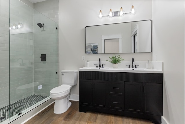 312 N Main St, Dickson, TN 37055 - full bath with toilet, wood finished floors, double vanity, a stall shower, and baseboards