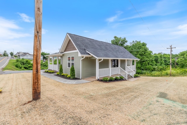 312 N Main St, Dickson, TN 37055 - view of front facade with a porch, a shingled roof, and driveway